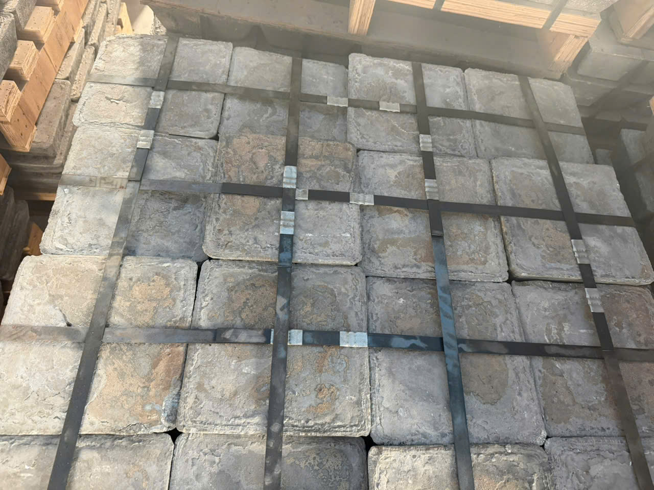 Top view of strapped antimony metal ingots showing surface texture and packaging